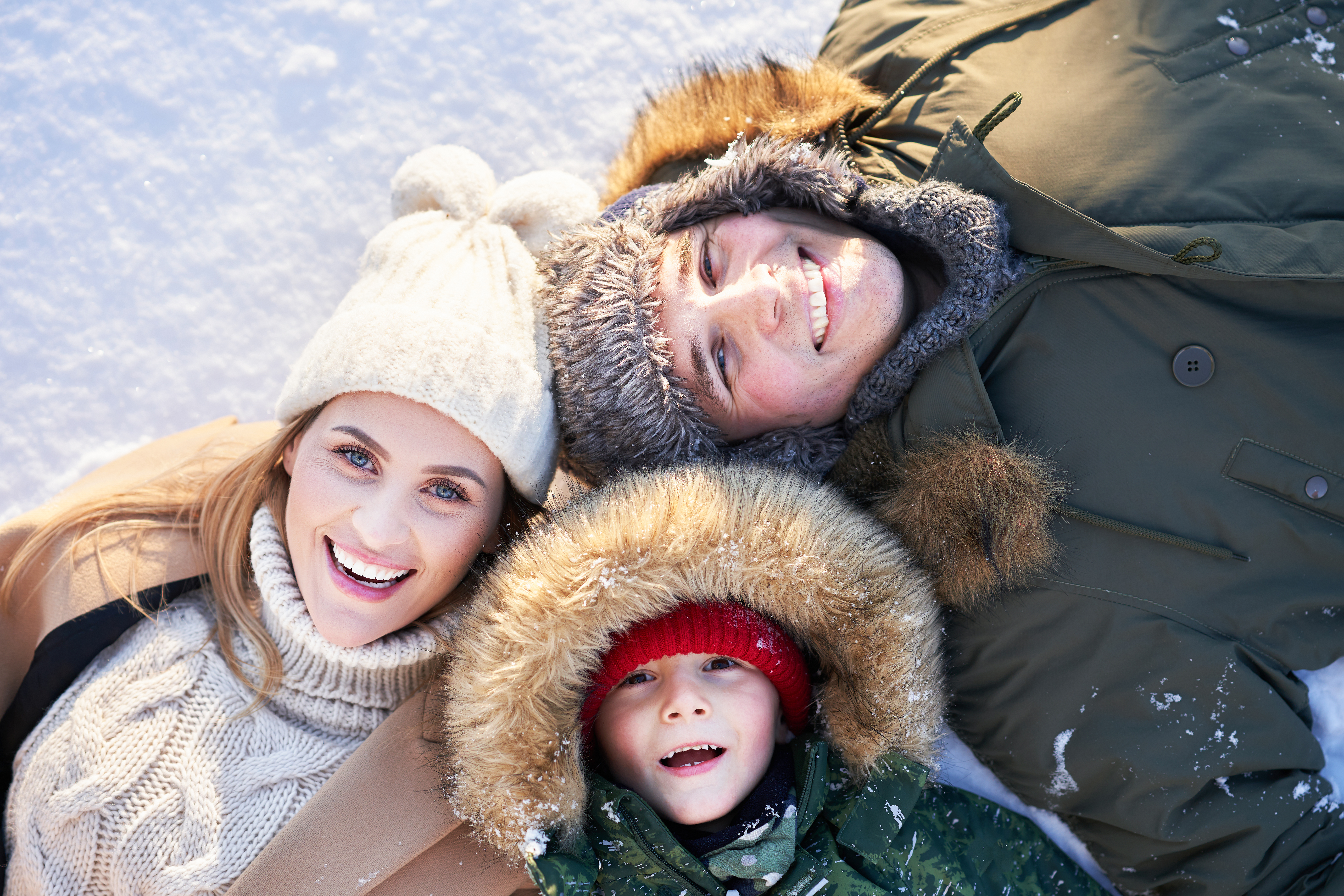 Nice happy family having fun on winter snow