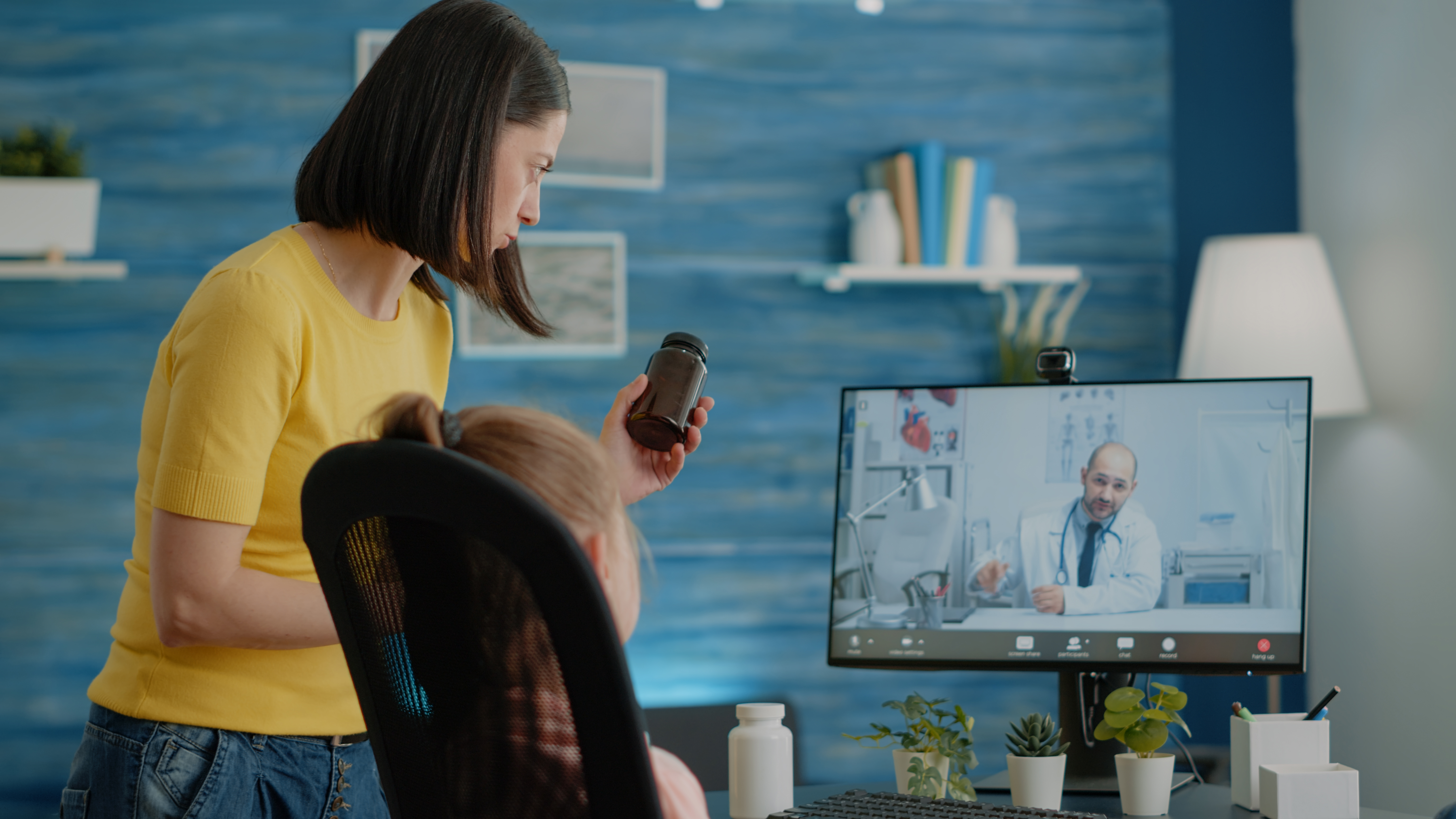 Worried parent asking doctor on video call about bottle of pills